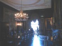 The dining room, with lots of mahogany.  Also, the ceiling, though it's 
hard to tell, has nice floral and fruity reliefs.  Artificially 
brightened.
